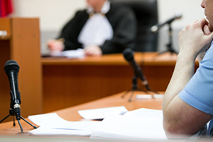 A man sitting at a desk in a courtroom