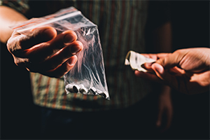 Dealer selling illegal drugs
