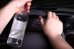 Driver with a bottle of alcohol