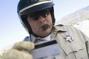 Middle aged policeman checking license