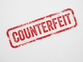 Red rubber stamp with the word COUNTERFEIT on a white background